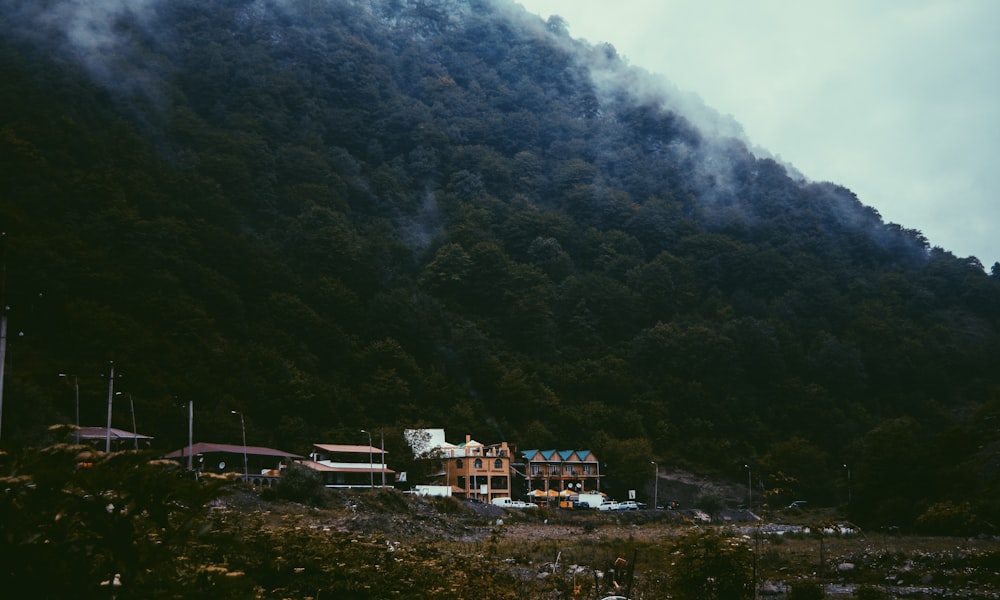 photography of buildings beside mountain during daytime