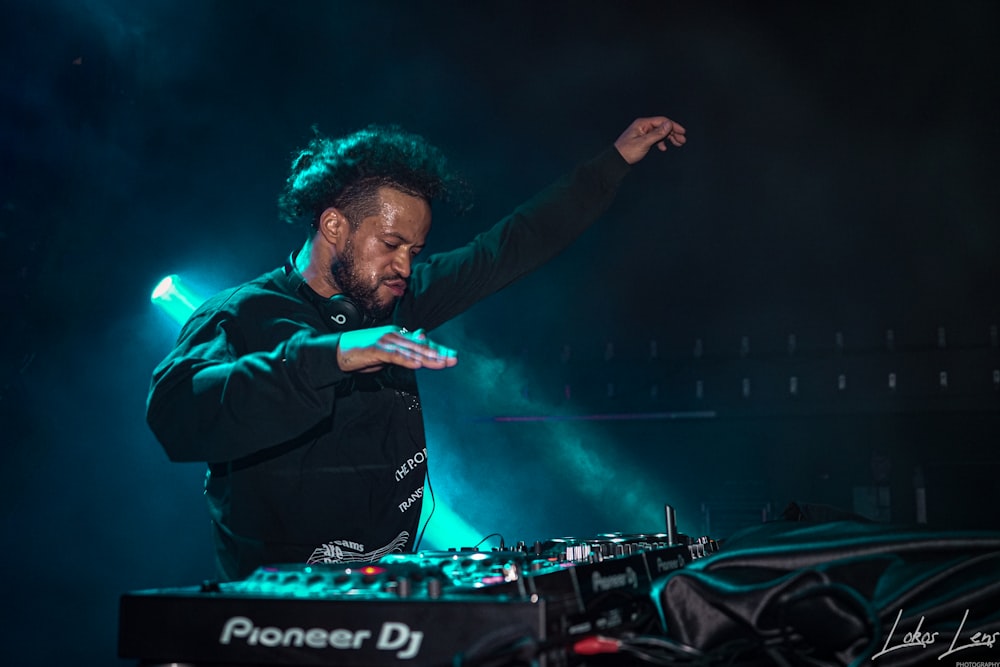 photography of man playing turntable