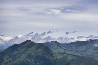 green mountains under white sky