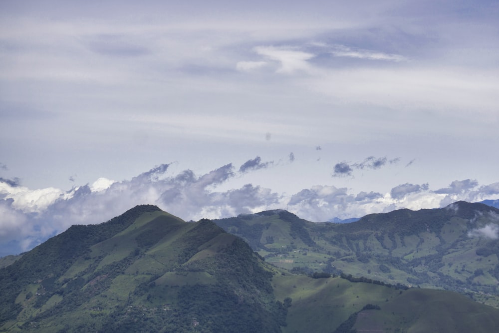 green mountains under white sky