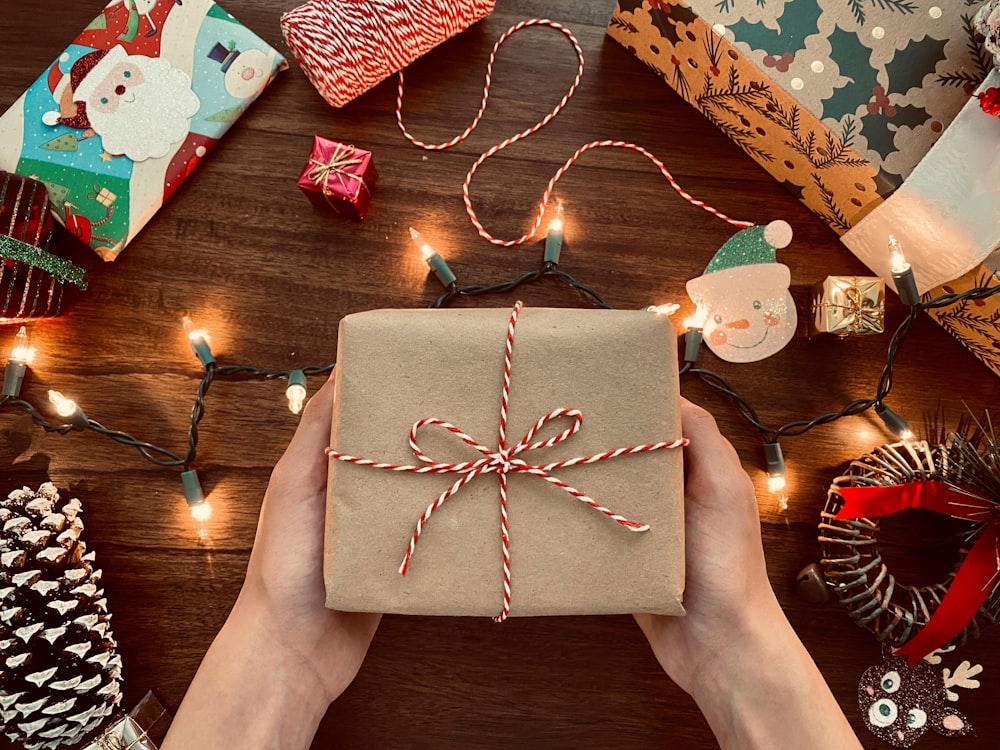 person holding brown box