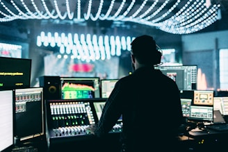silhouette of man using audio mixer