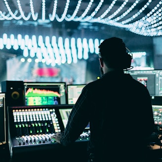 silhouette of man using audio mixer