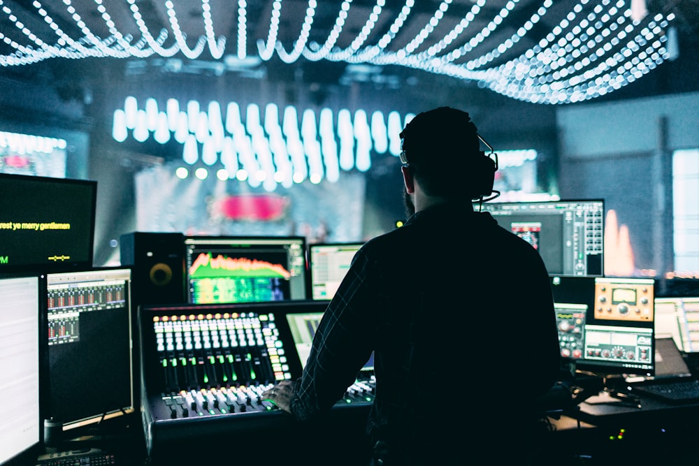 silhouette of man using audio mixer