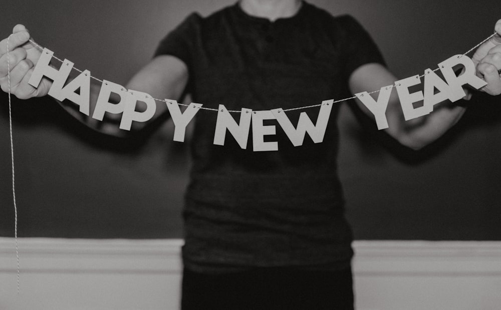 man holding happy new year decor