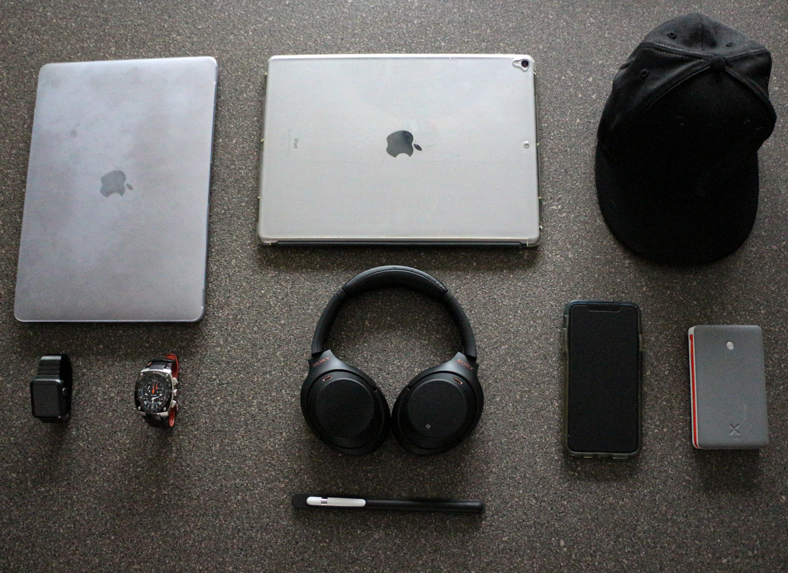 A pair of black wireless headphones resting on a tabletop