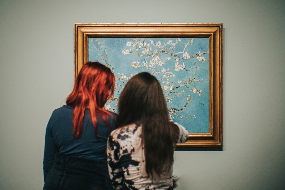 two women standing near Almond Blossom painting by Vincent Van Gogh