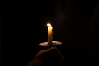 A single lit candle symbolizing hope and remembrance.