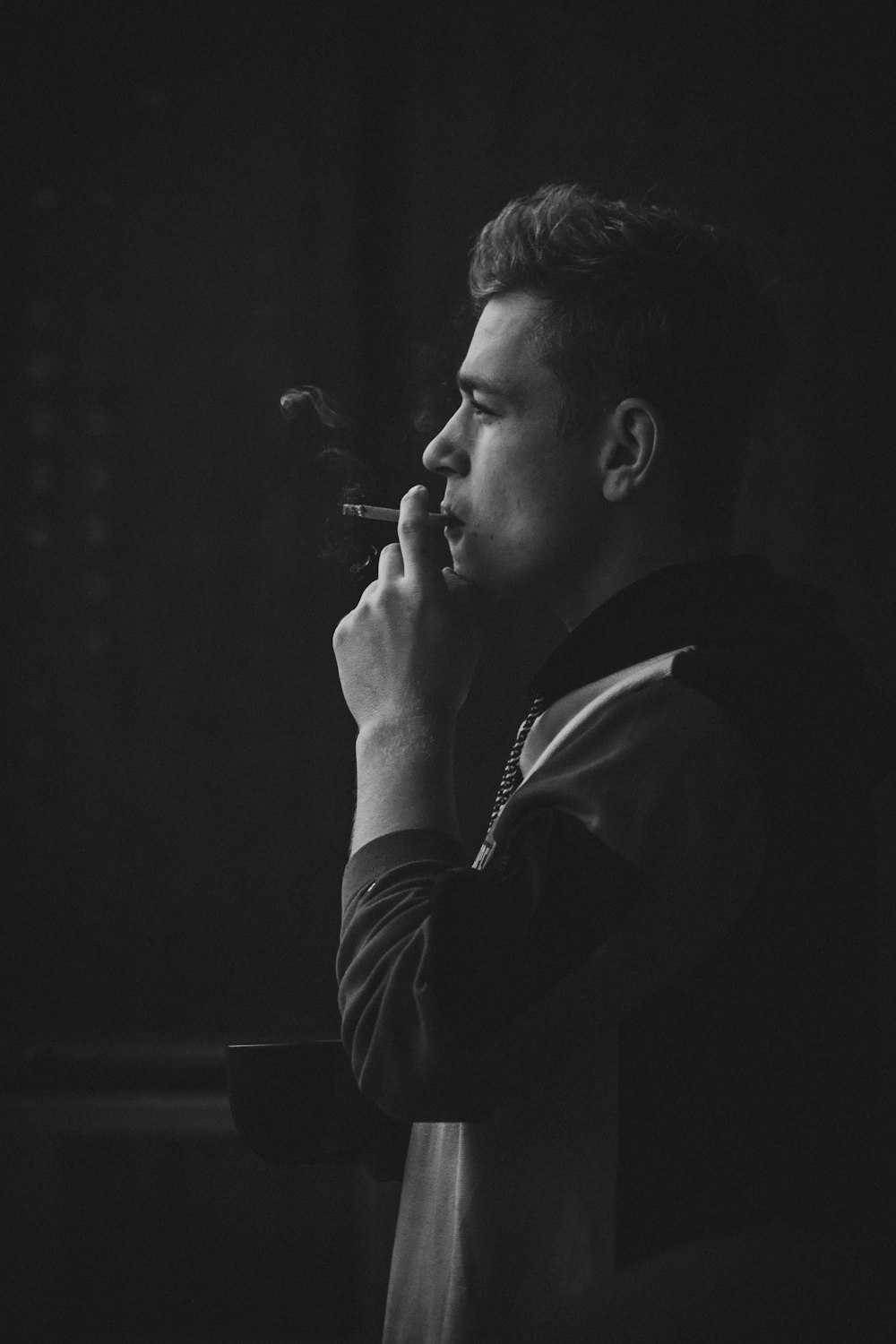 photography of man using cigarette
