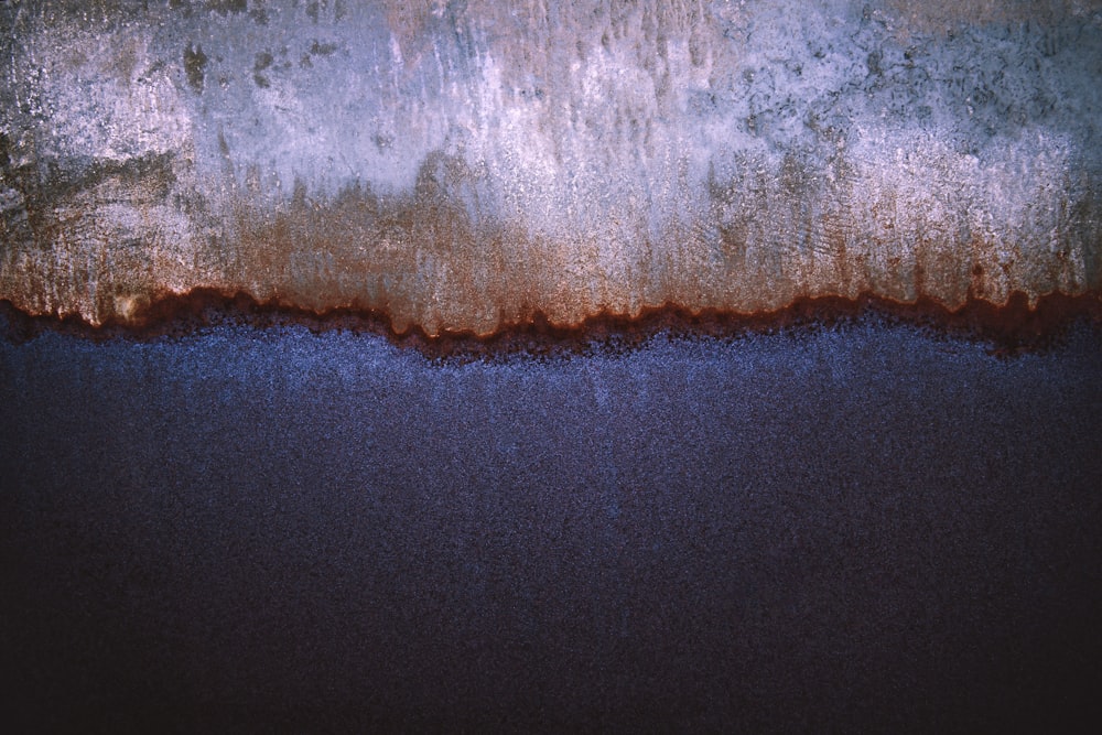 an abstract painting of blue and brown colors