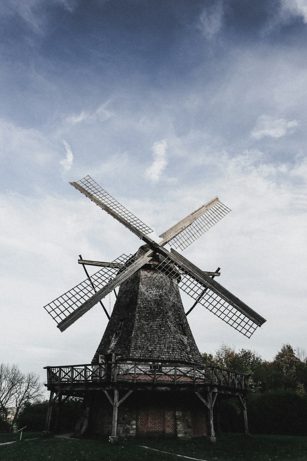 windmill under blue and white sky