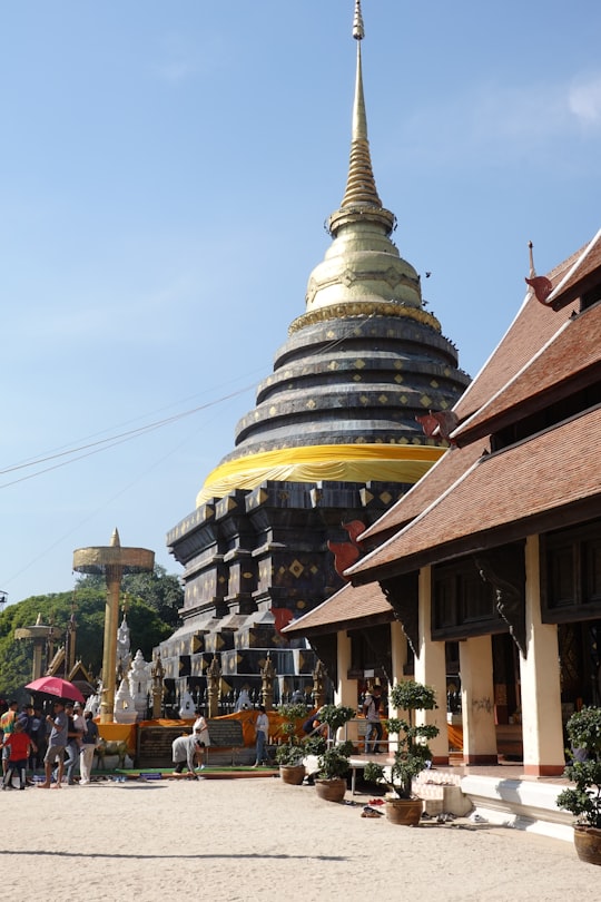 yellow, black, and gray concrete temple in Wat Phra That Lampang Luang Thailand