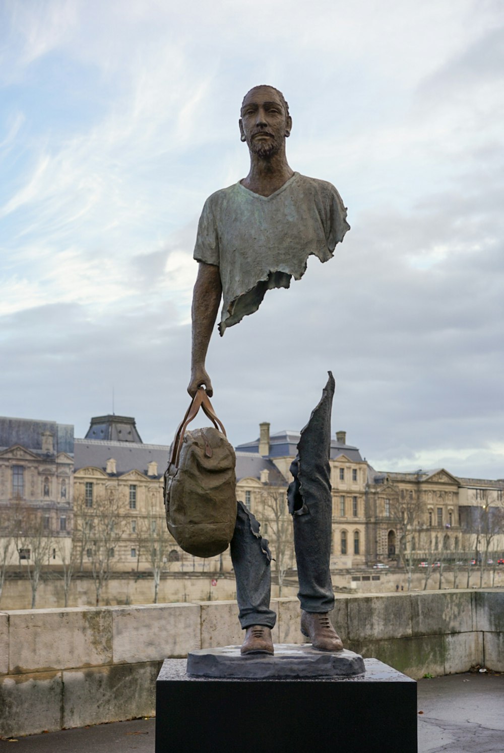 standing man with bag statue