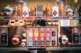A display of Molton Brown products arranged on shelves. The setup includes various bottles, presumably of scented products, and decorative metallic spheres. The reflection on the spheres adds an interesting visual element.