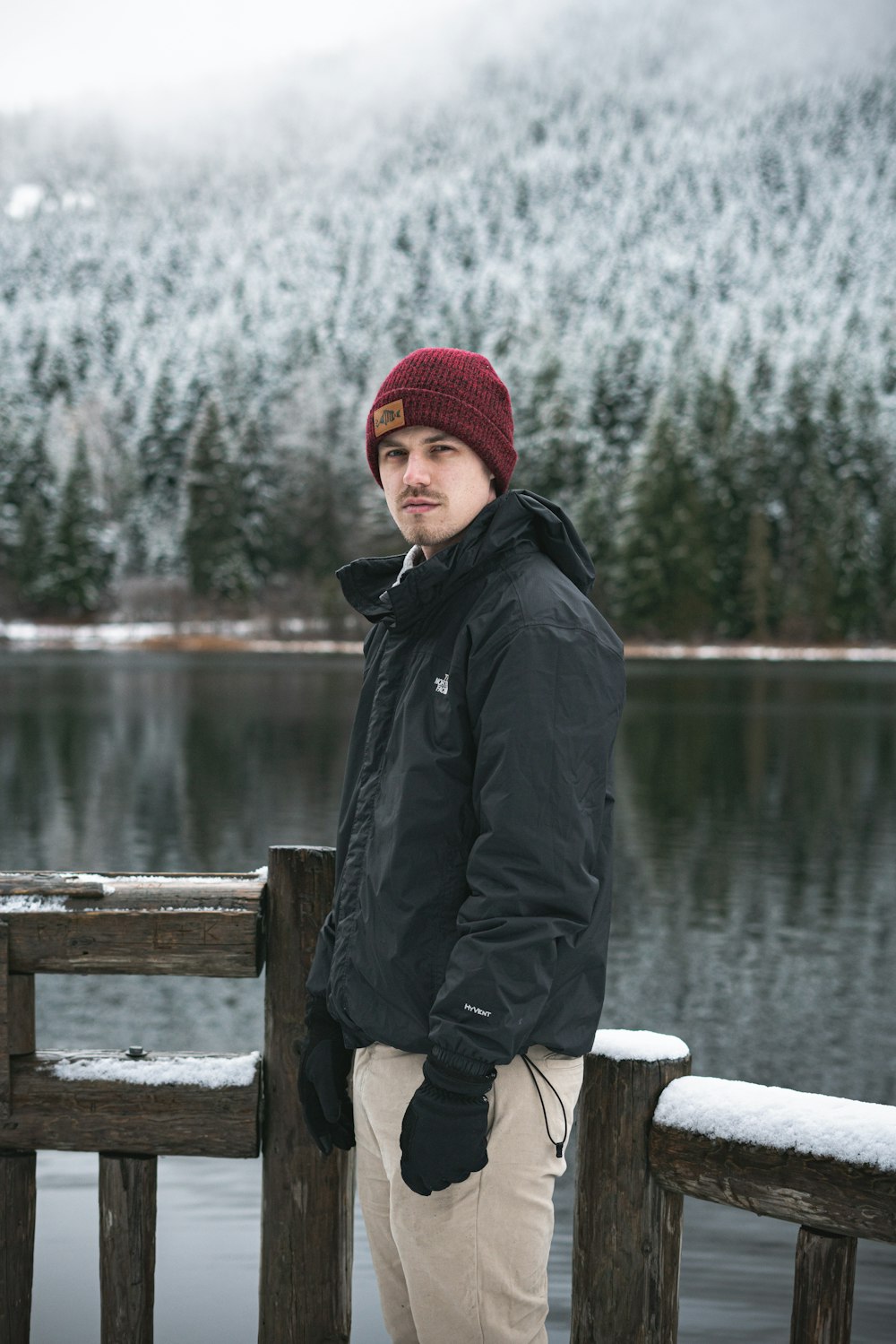 man looking at the camera standing beside railing