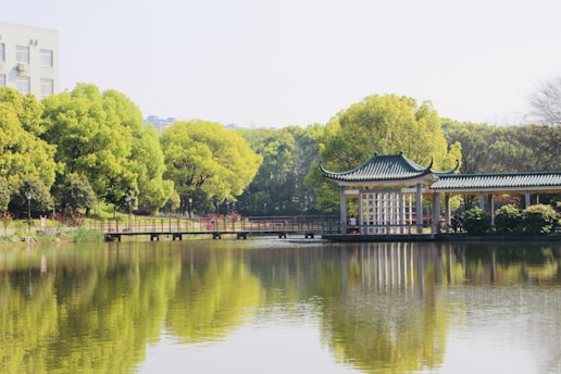 gray concrete shed beside body of water