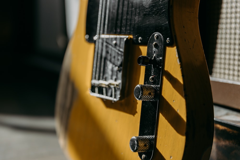 selective focus photography of brown guitar