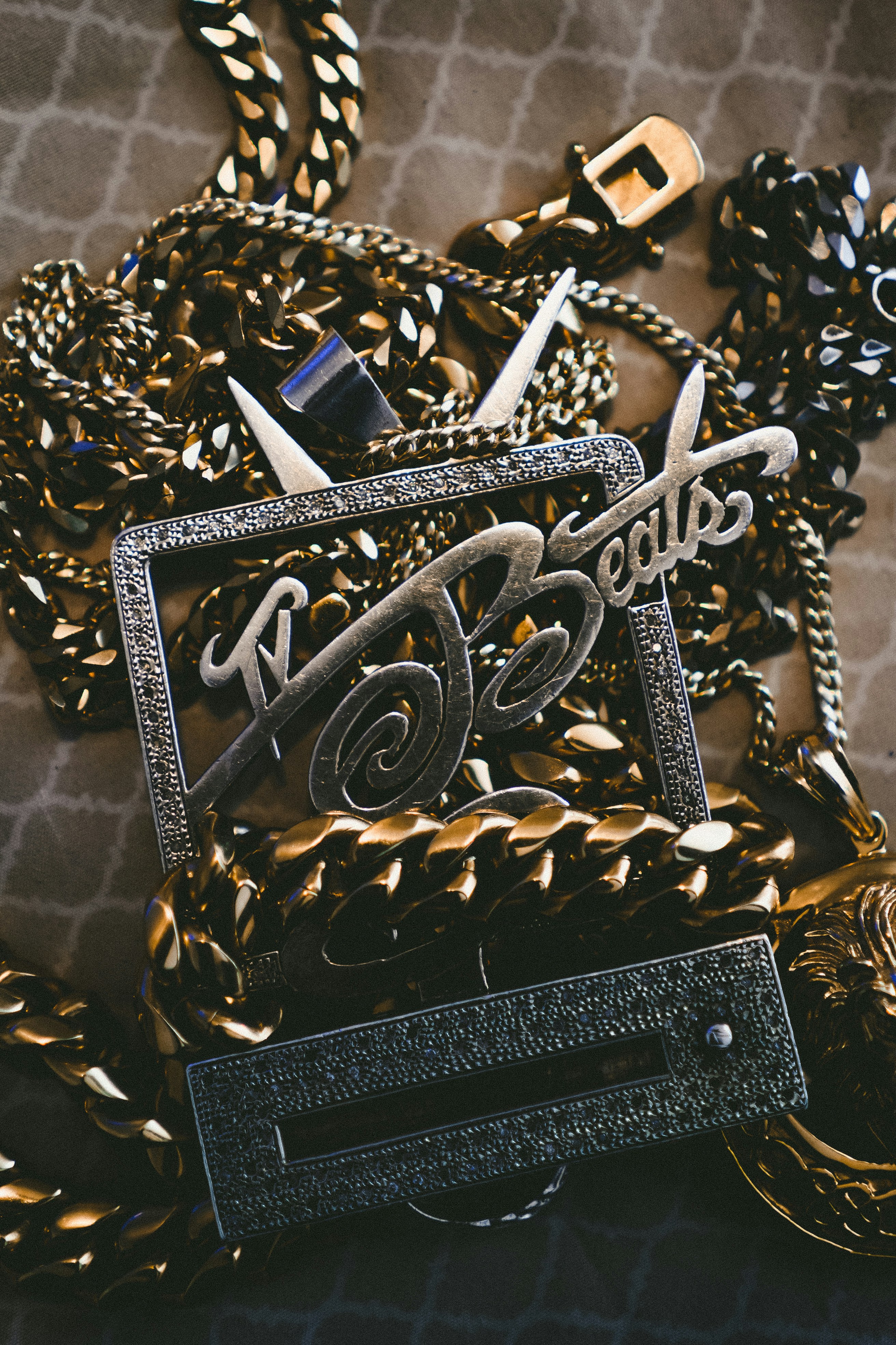 silver-colored Beats pendant