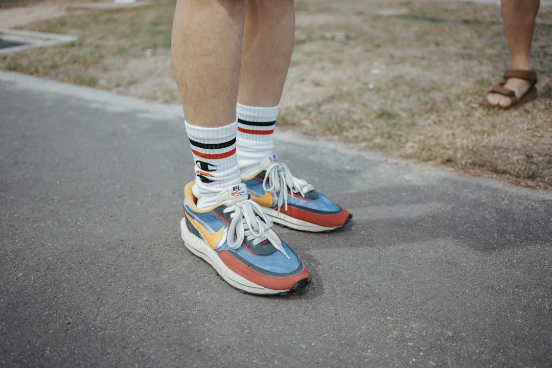 person wearing multicolored Nike shoes standing