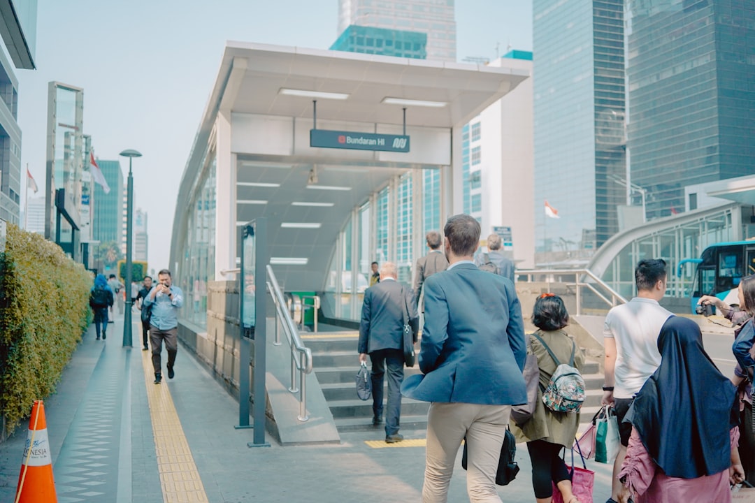 people walking on pathway near buildings during daytime