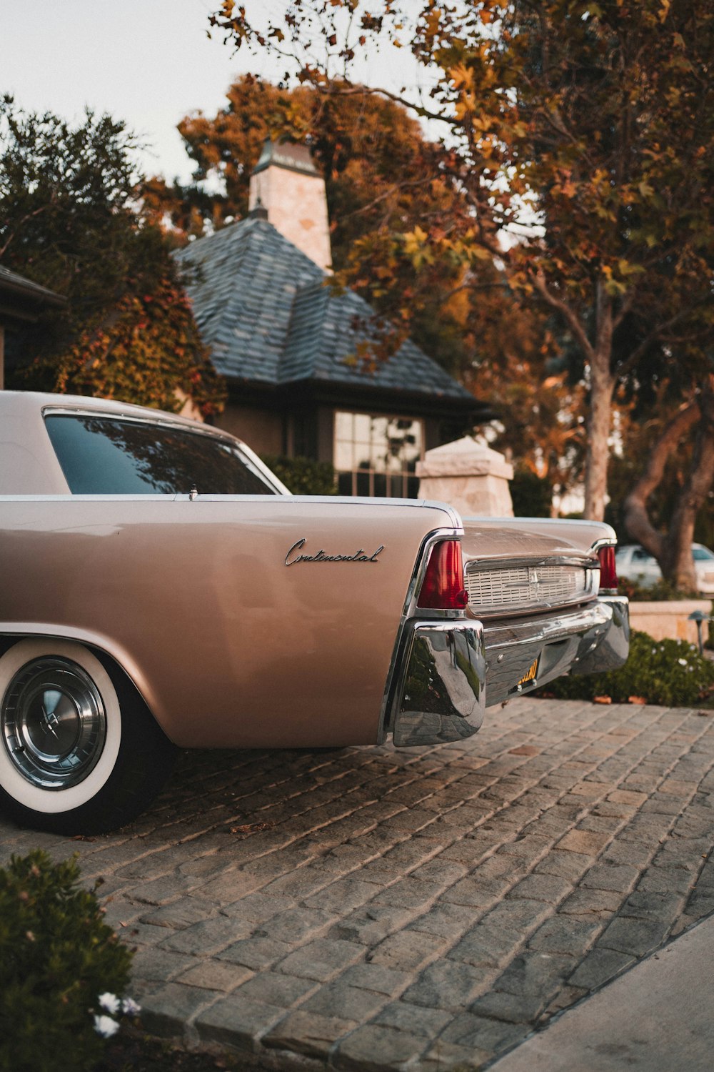 brown vehicle parking on pavement