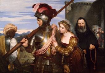 A medieval knight in armor stands prominently, holding a spear, accompanied by a woman in a luxurious dress gently holding his arm. Beside them, a monk clad in a dark habit holds a rosary. In the background, a dark-skinned man wearing a turban carries a large crossbow. The setting includes a stone fortress and mountains under a blue sky.