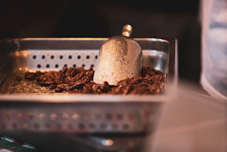 A warm, inviting office space with shelves displaying colorful coated nuts and shiny machinery in the background.