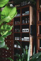 A vintage storage cabinet with distressed paint, showcasing neatly organized craft supplies.