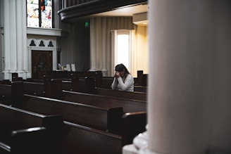 woman praying in cathedral