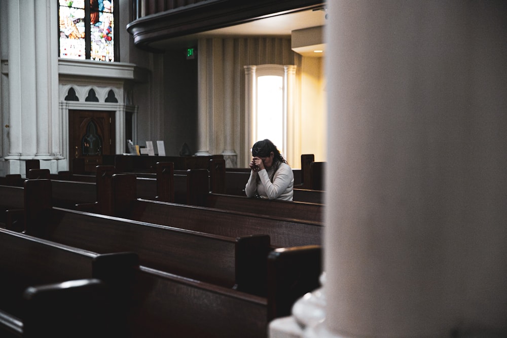 woman praying in cathedral