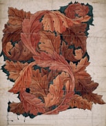 A detailed ink drawing of natural elements like leaves and branches.