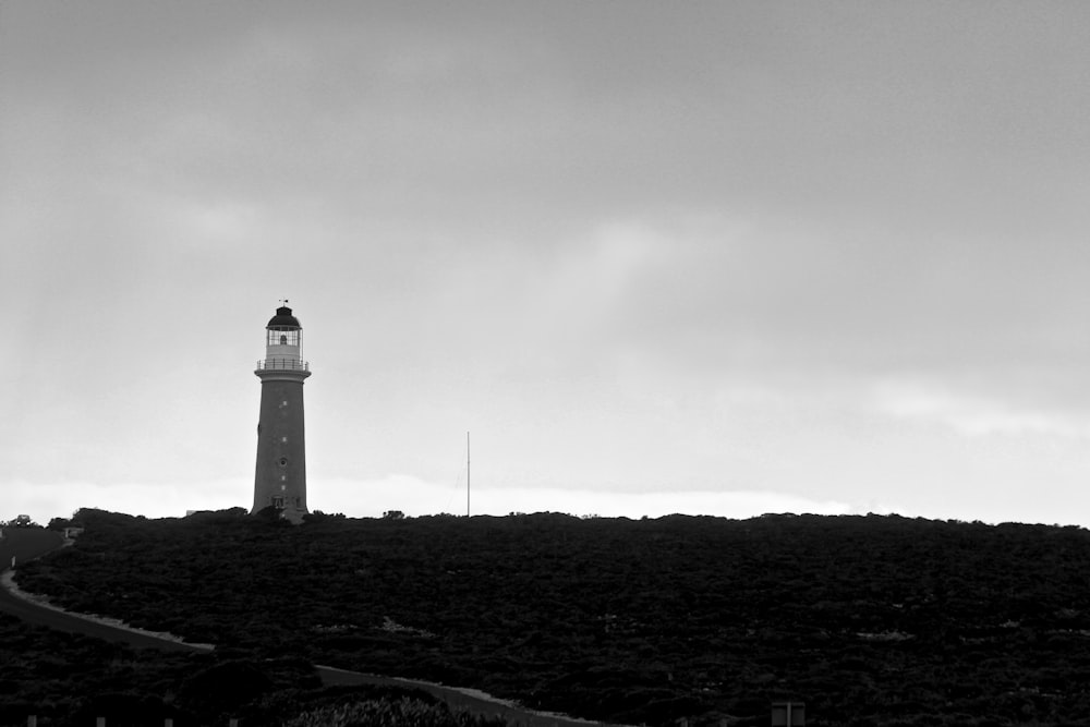 lighthouse grayscale photo