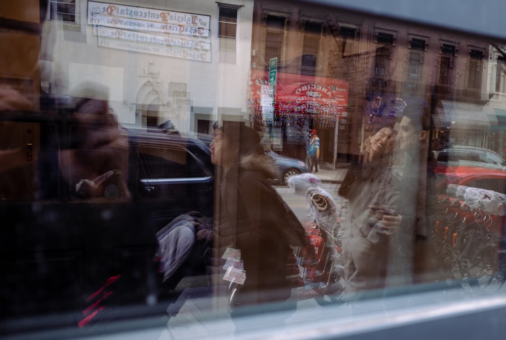 a reflection of a woman in a window