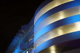 Sophisticated architectural blueprint with golden technical lines on deep blue background.