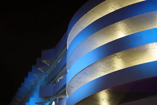 A sleek architectural blueprint overlaying a midnight blue background with burnished gold accents.