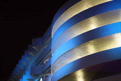 Luxurious navy blue and gold minimalist architectural detail with sleek lines and modern lighting.