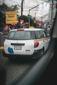 white Nissan vehicle on road
