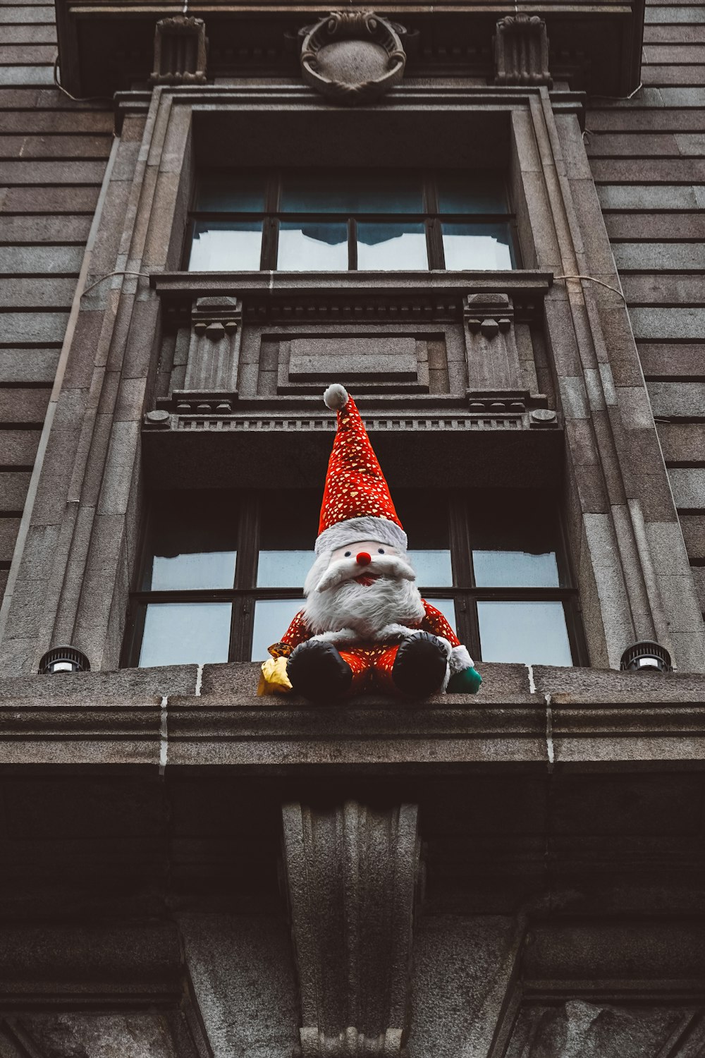 elf plush toy sitting on window sill