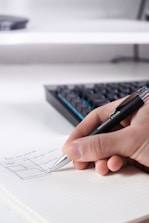person writing on white paper