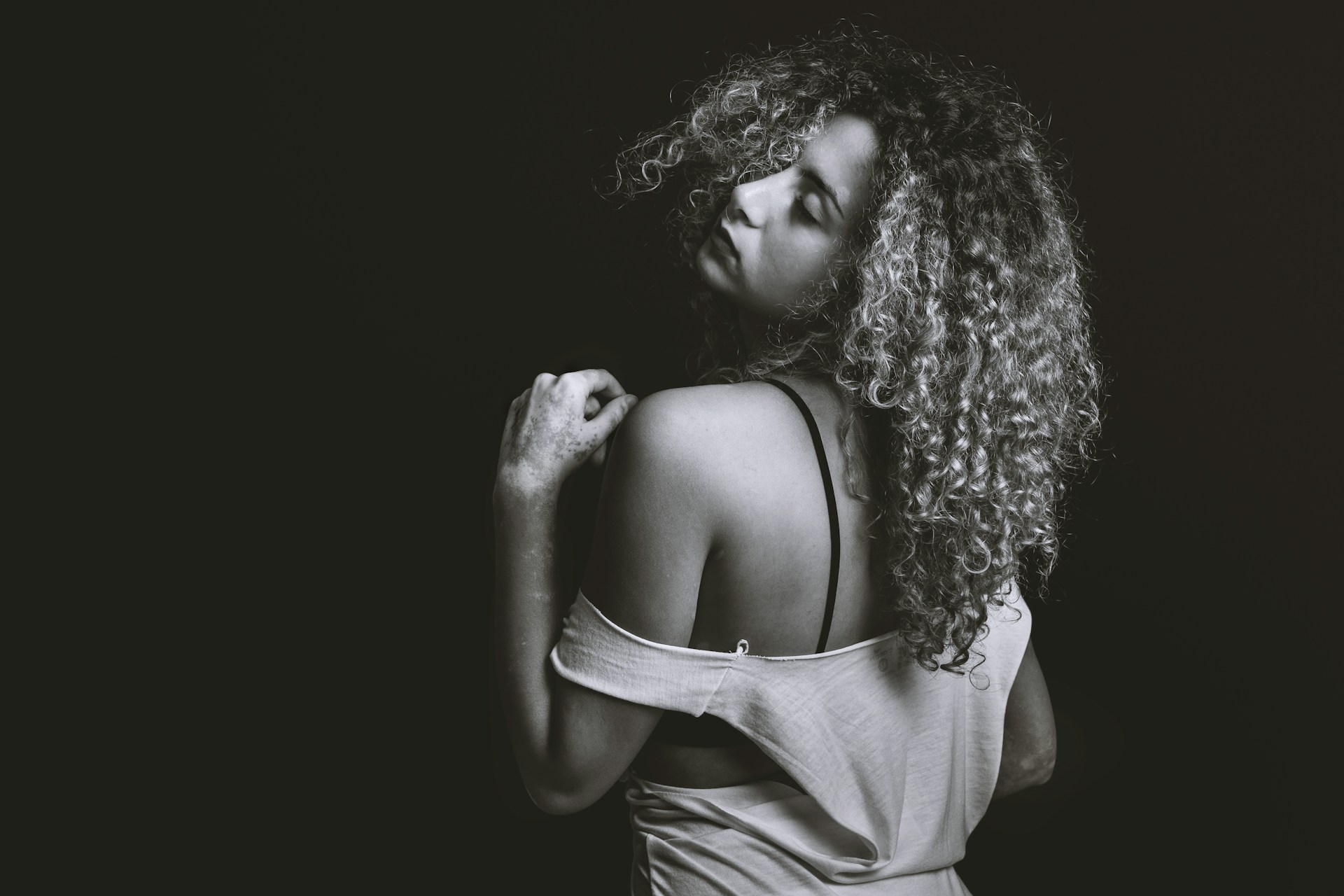 grayscale photography of woman wearing sleeveless top