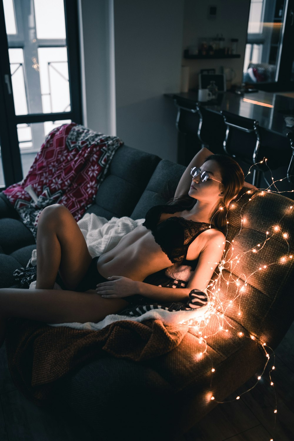 woman lying on sofa inside room