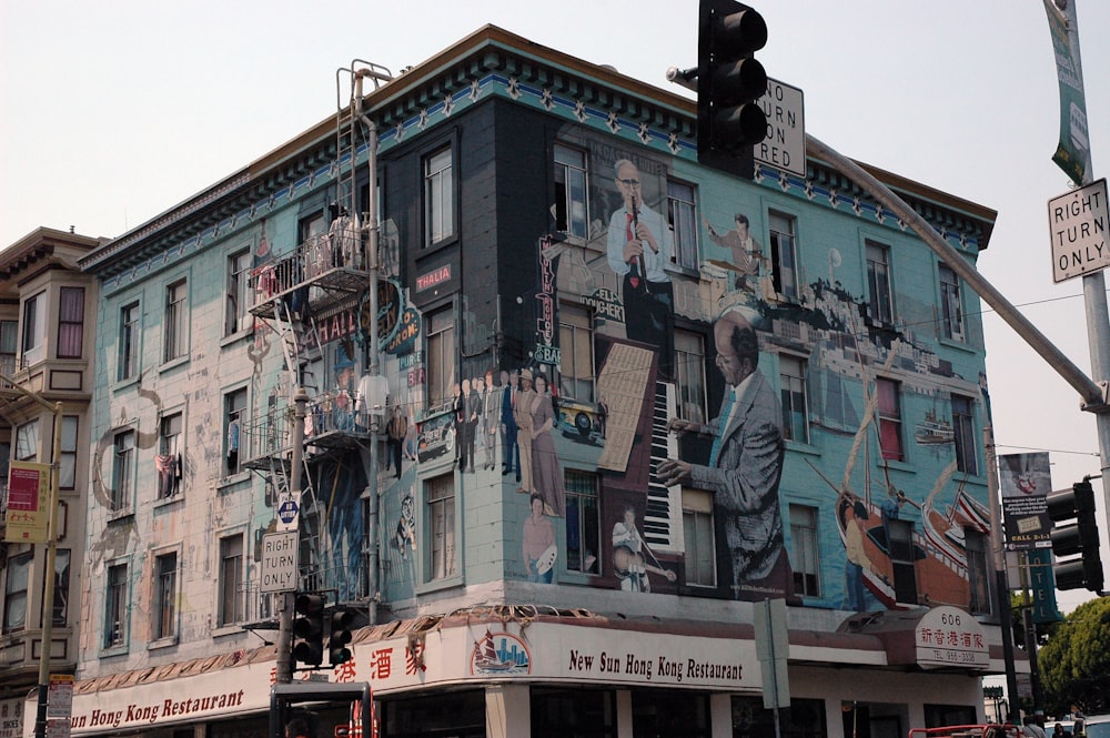 building with murals near traffic light during day