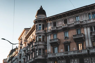 Elegant luxury apartment building facade in historic Granada city center at sunset.