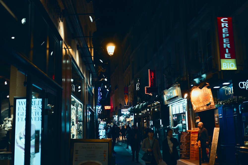 photography of people waking near street during nighttime