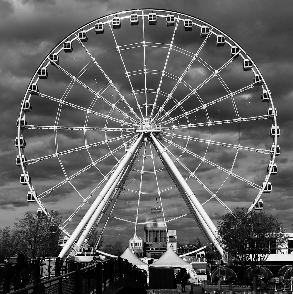 grayscale photography of ferris wheel near building