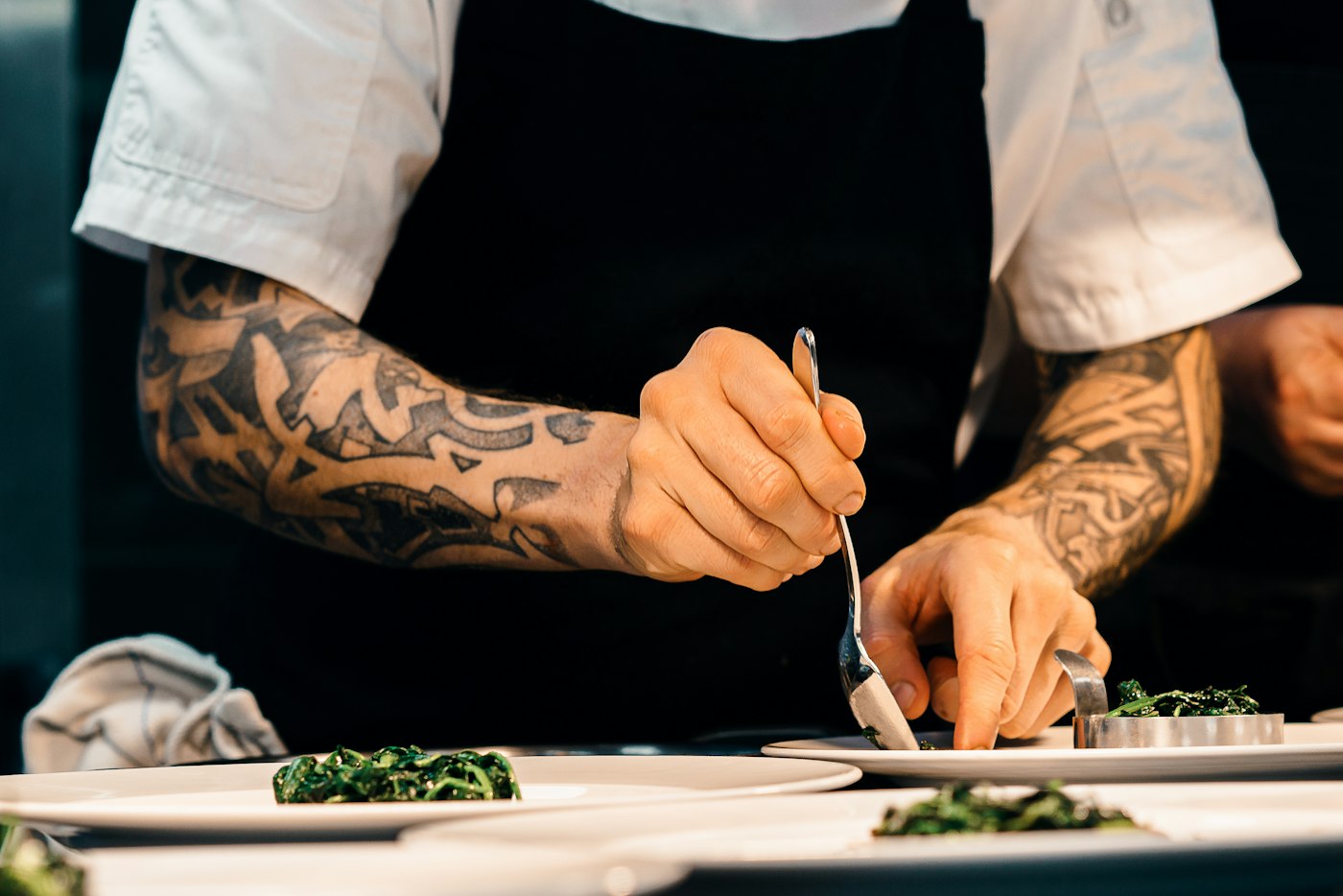 Chef Roberto Medda plating a fine-dining course