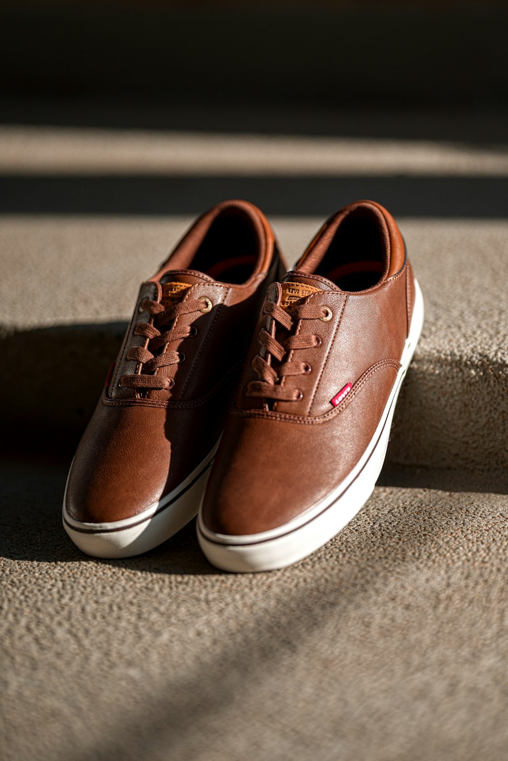 pair of brown low-top sneakers