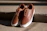 Close-up of a stylish sneaker from klans on a concrete step with soft natural light.