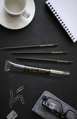 A neatly arranged desk featuring Inkspire's colorful pens and notebooks.