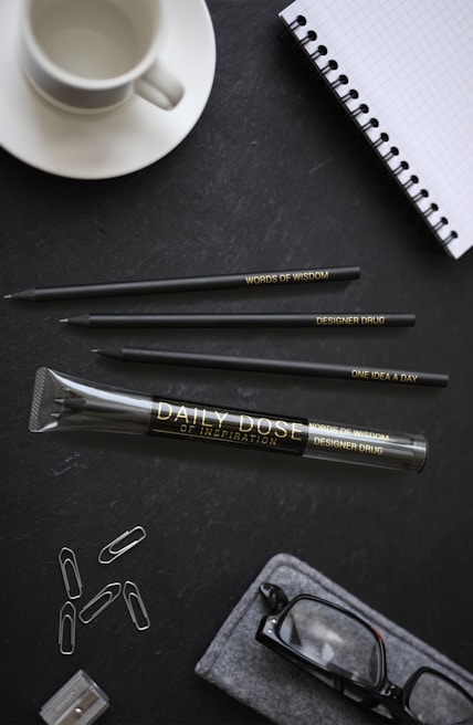 Image of a neat desk with accounting books, a laptop, and a cup of coffee, symbolizing focus and dedication